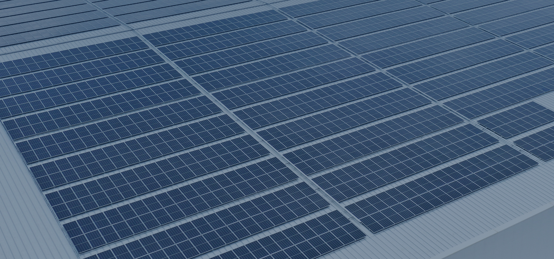 Metal roof covered with a photovoltaic panel array, seen from above